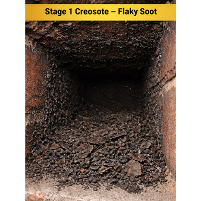 Stage 1 creosote in a chimney: flaky soot and loose powdery deposits on chimney walls.